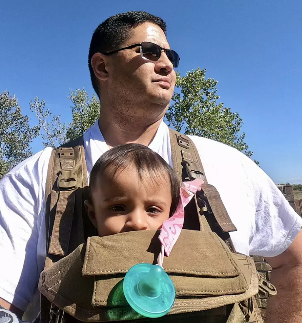 Dad using TBG baby carrier with sun shade